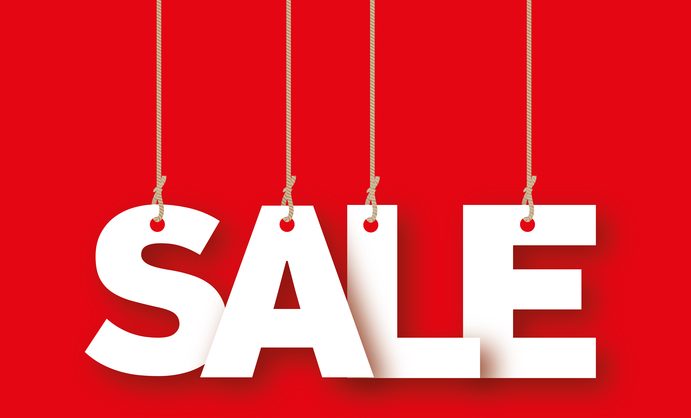 Sale - the word of the white letters hanging on the ropes on a red background